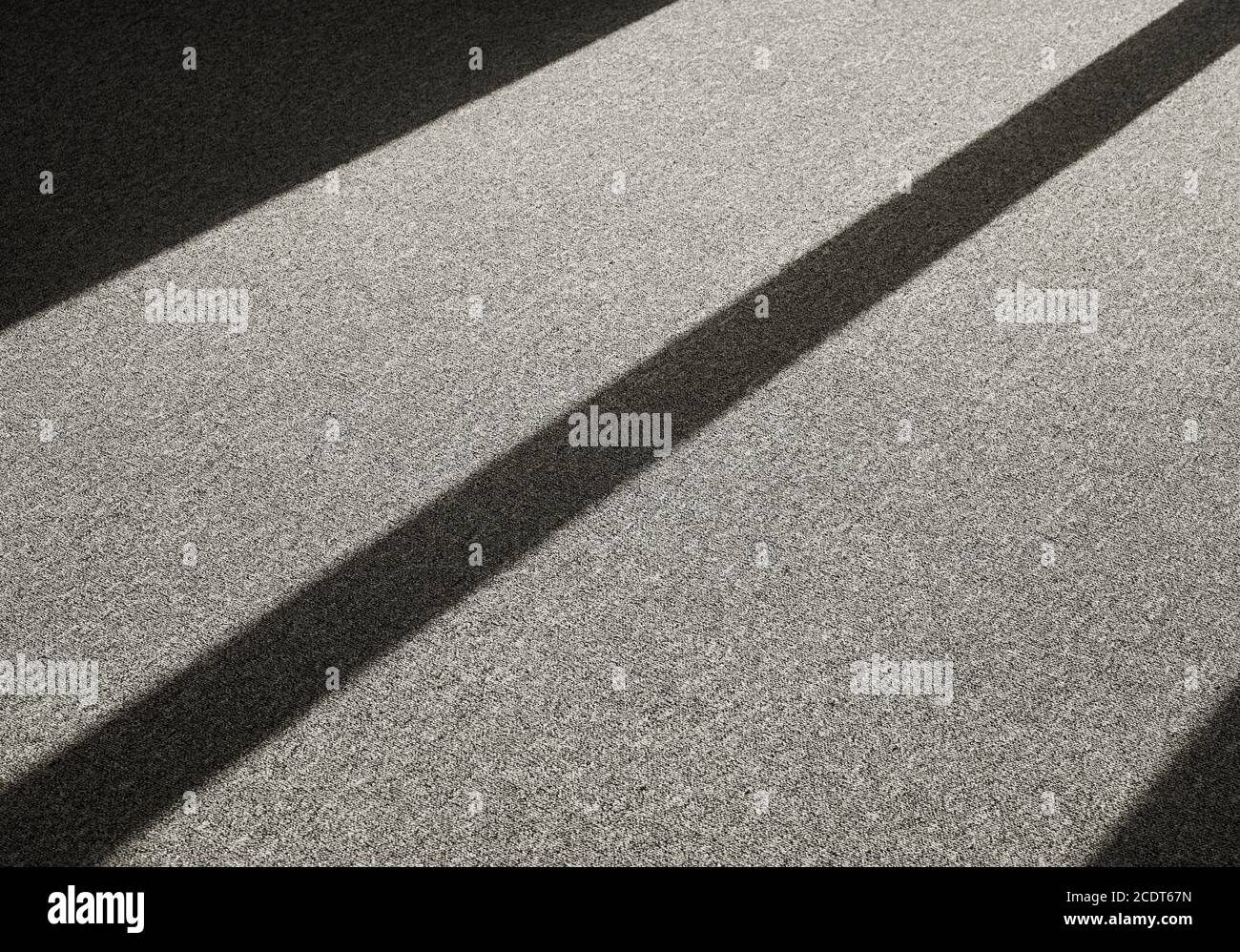 Shadow by incident light on a carpet floor in front of a window Stock Photo