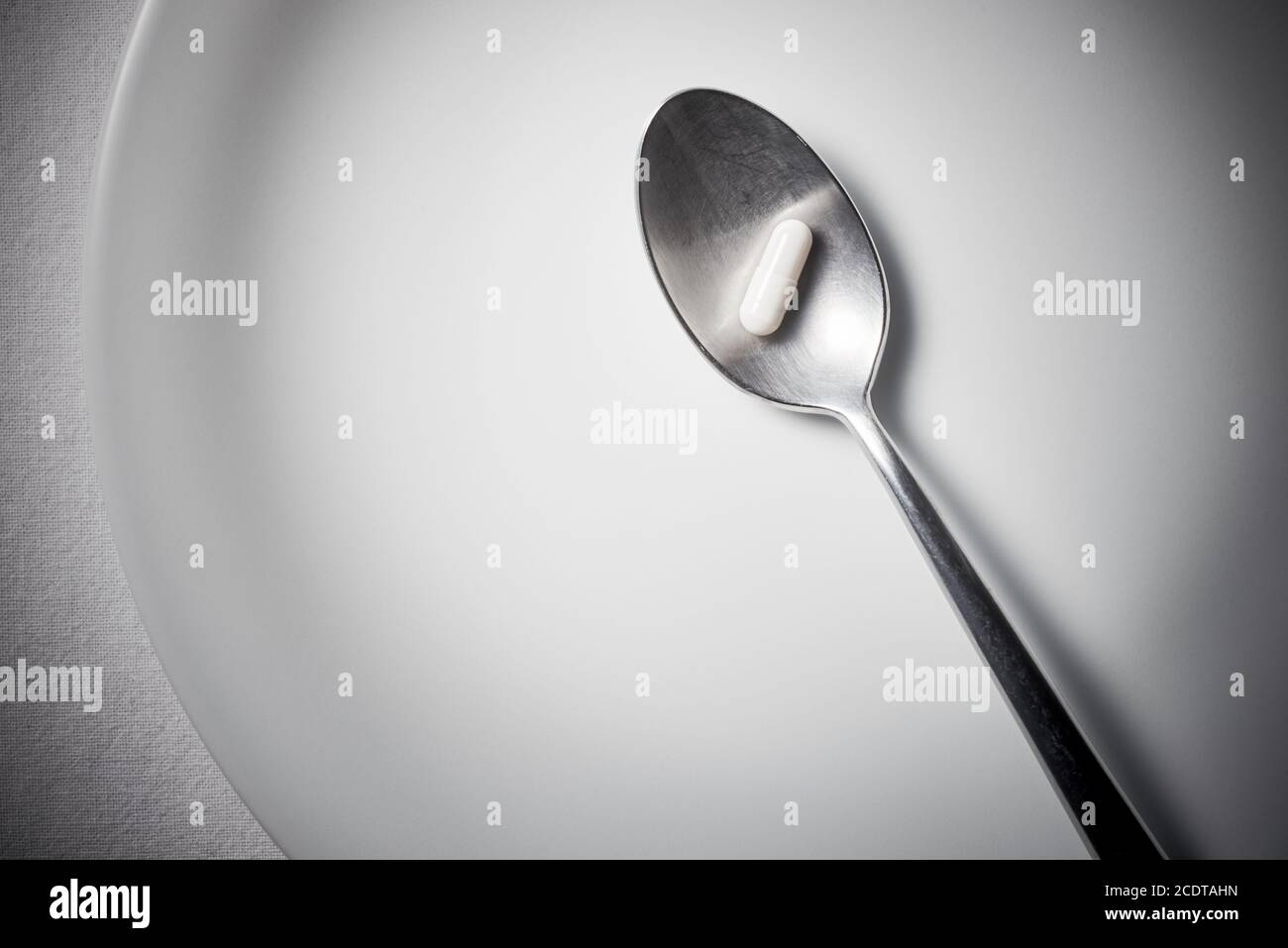 Spoon with Capsule Stock Photo