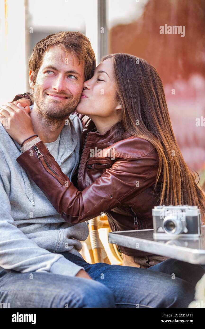 Girlfriend kiss couple young woman kissing boyfriend on holiday travel