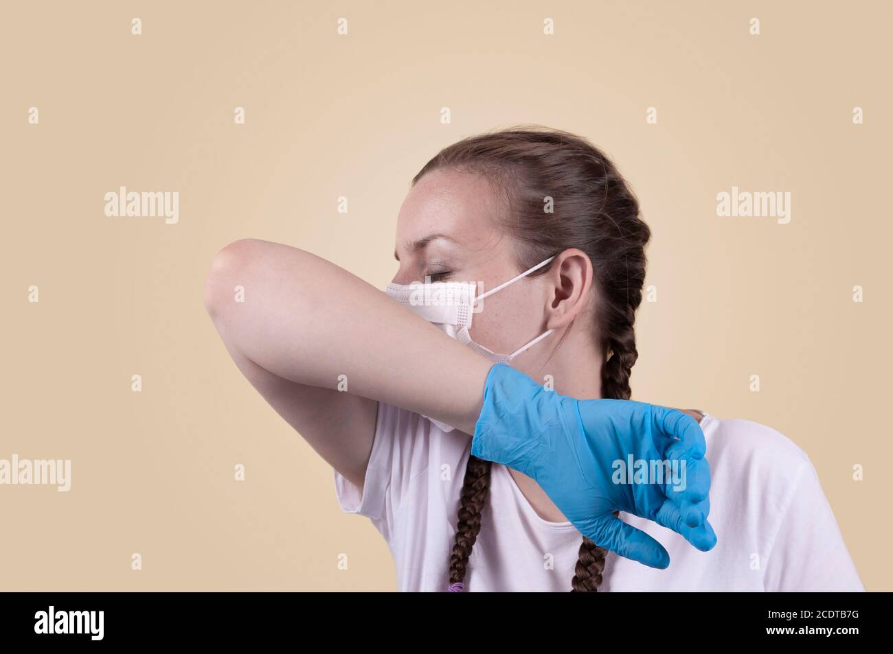 Girl in a medical mask and gloves. Girl on a yellow background. The ...