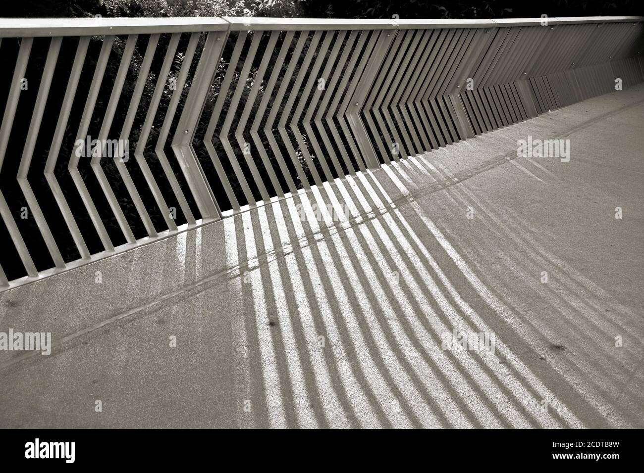 Shadows of a bridge railing on the edge of the city of Prague Stock Photo
