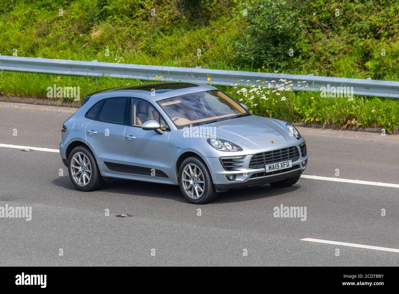2015 silver Porsche Macan S S-A; Vehicular traffic moving vehicles, cars driving vehicle on UK roads, motors, motoring on the M6 motorway highway network. Stock Photo