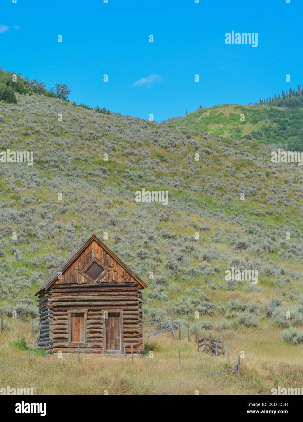 Old log cabin, abandoned in the country hillside of Rocky Mountains in