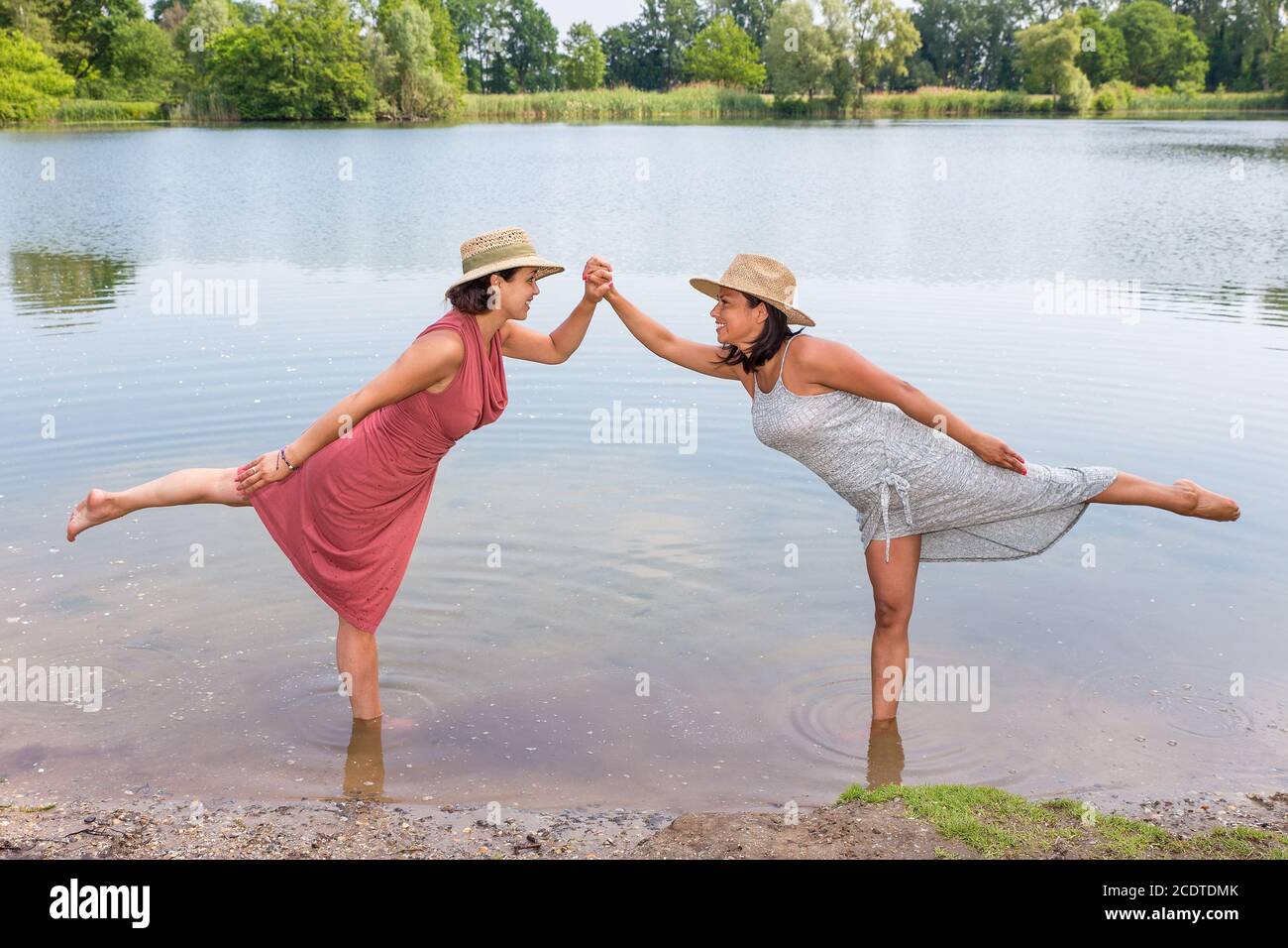 Two women standing together in natural water Stock Photo