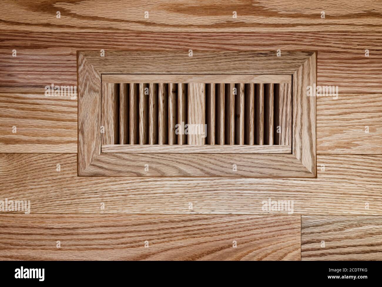 Wooden floor vent on red oak floor Stock Photo