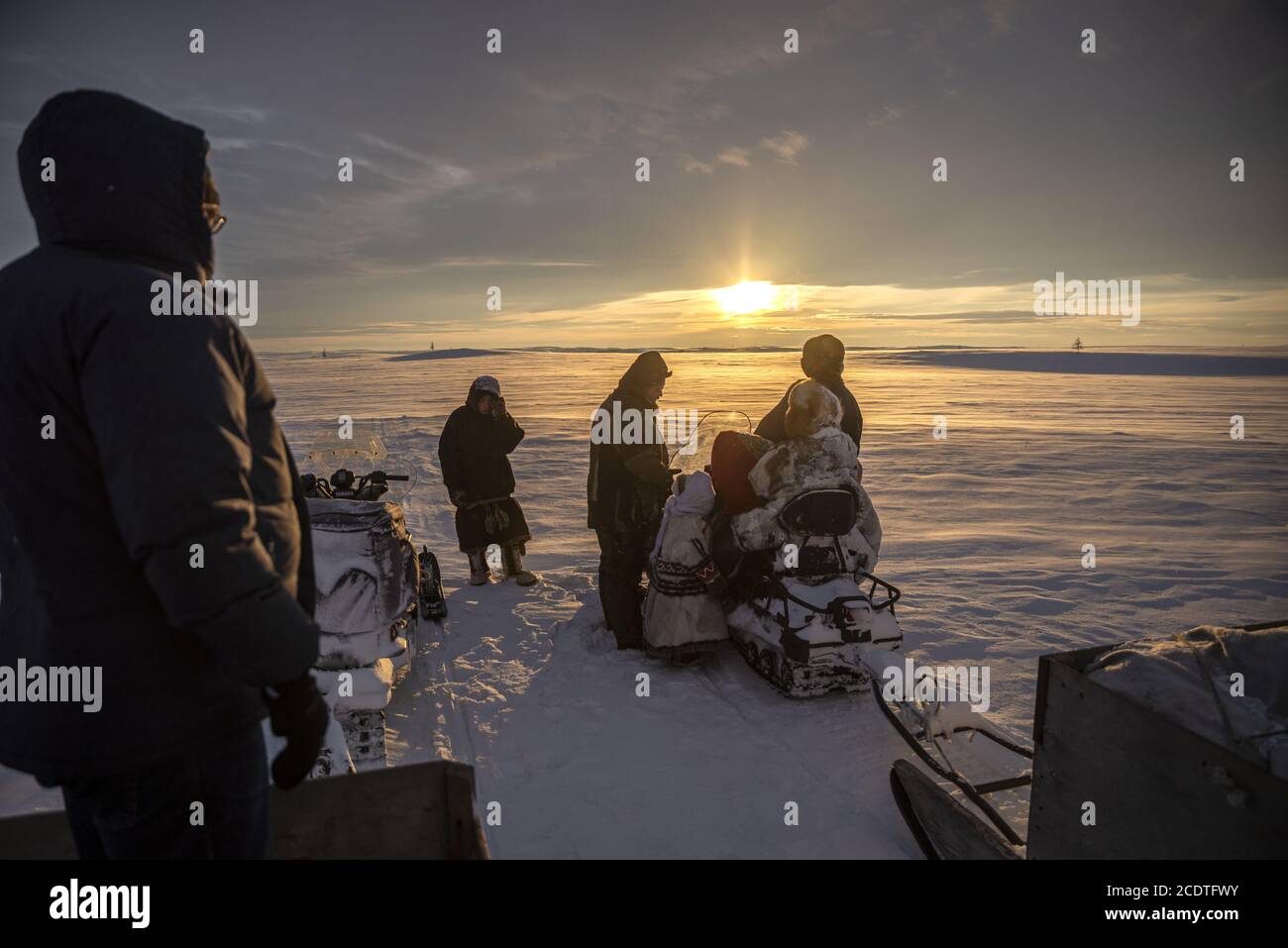 Nenets people moving in a snowy landscape with a snowmobile, Yamalo-Nenets Autonomous Okrug, Russia Stock Photo