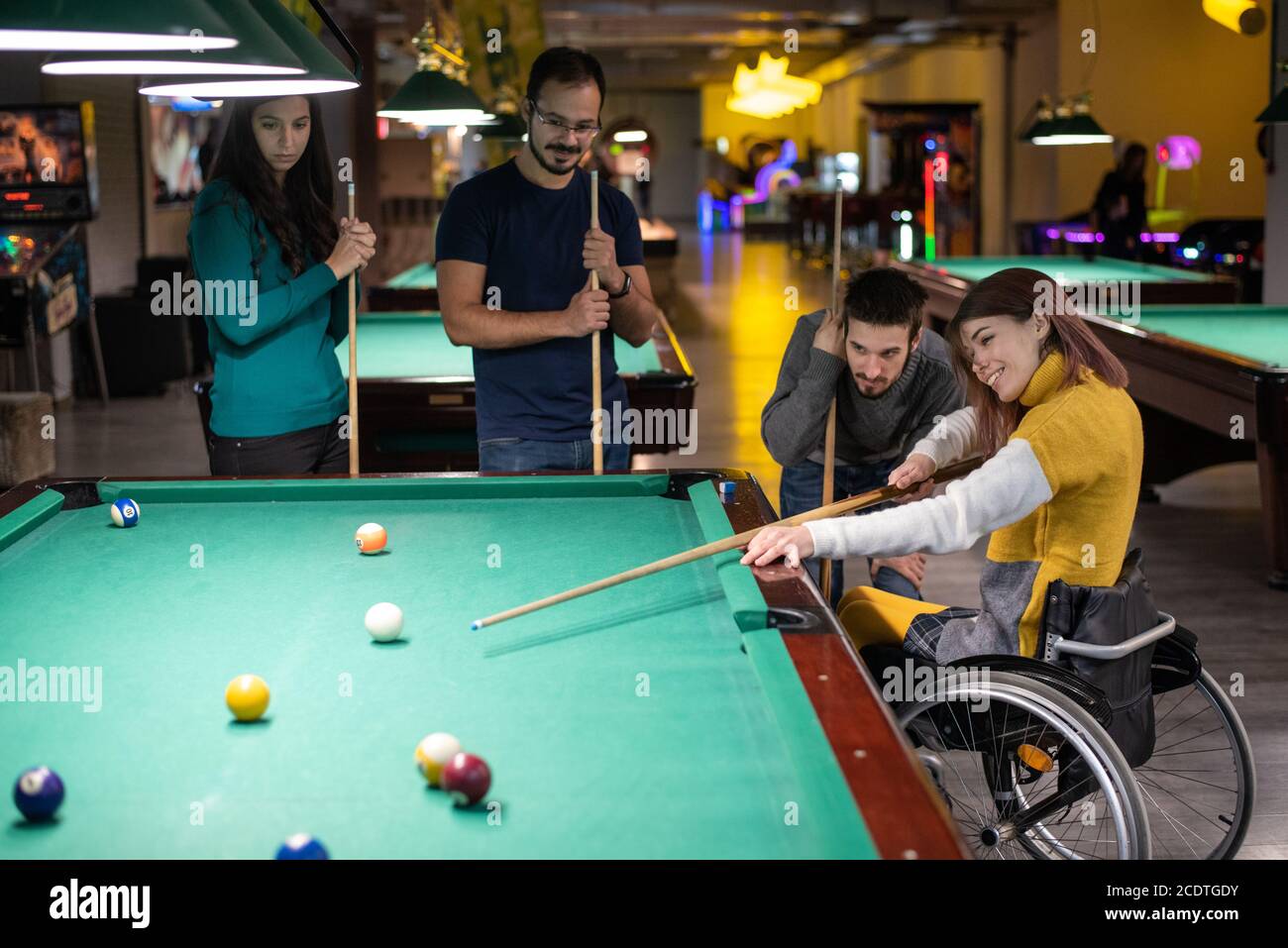 Billiards game. young friends playing pool together Stock Photo - Alamy