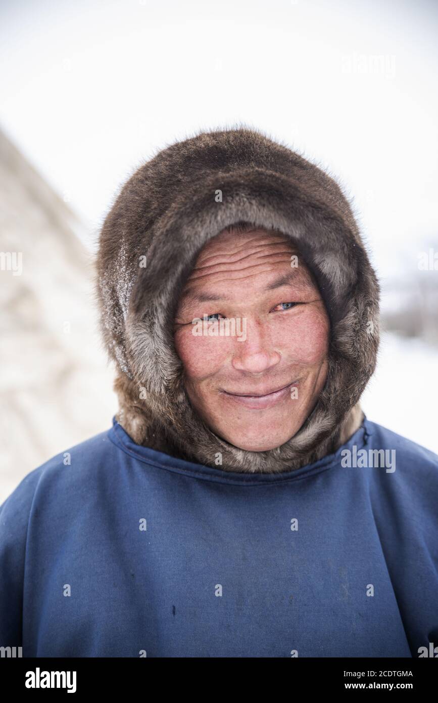 Portrait of an adult nenet man with traditional fur hood, Yamalo-Nenets ...