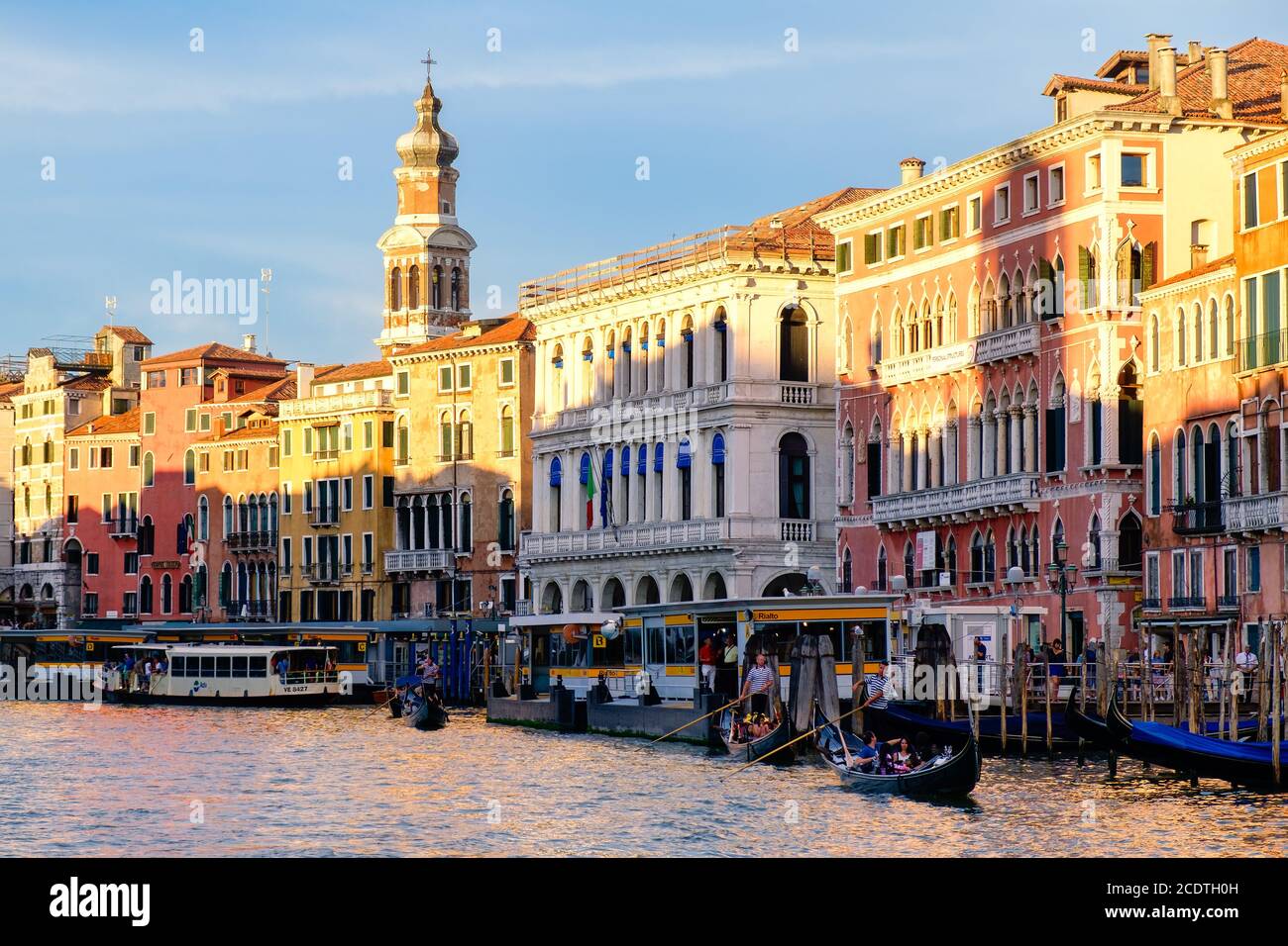 VENICE,ITALY - JULY 25,2017 : Gondolas and vaporetti on the Grand Canal in Venice surrounded by old palaces Stock Photo