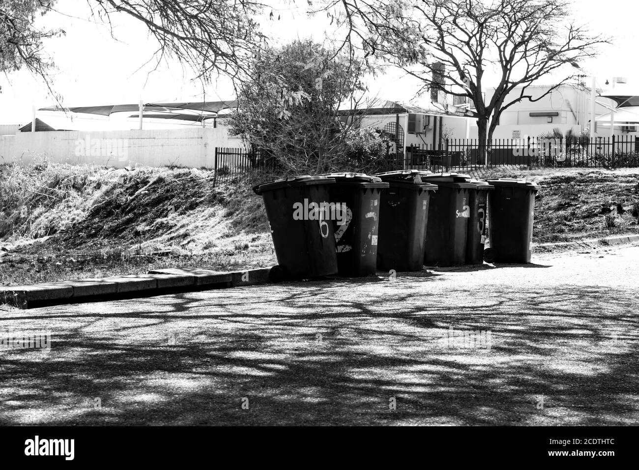 Six rubbish or gabage bins after ready for collection Stock Photo