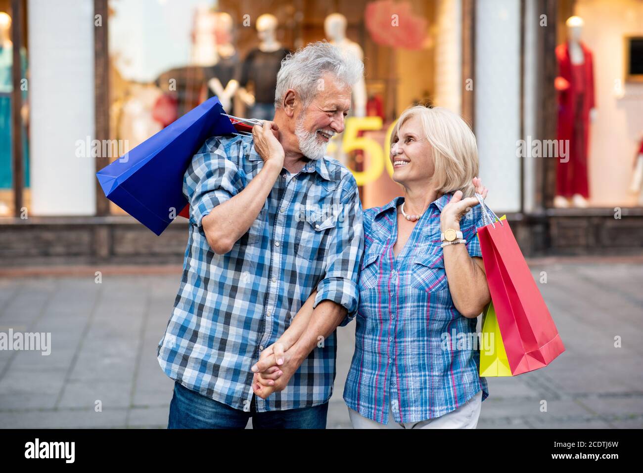 Happy senior couple with shopping bags Stock Photo