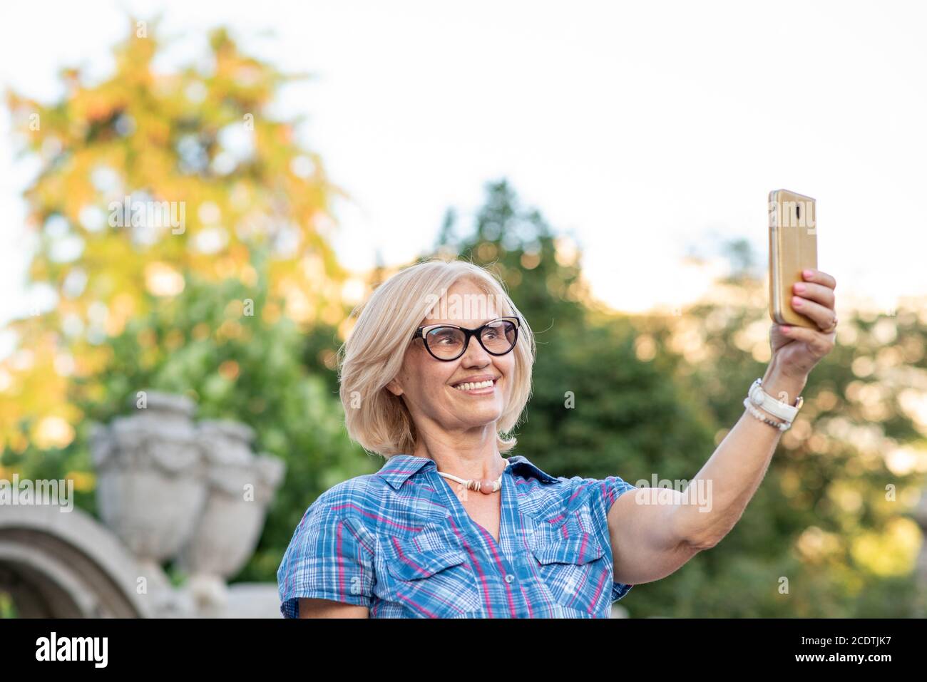 Beautiful senior woman taking selfie Stock Photo