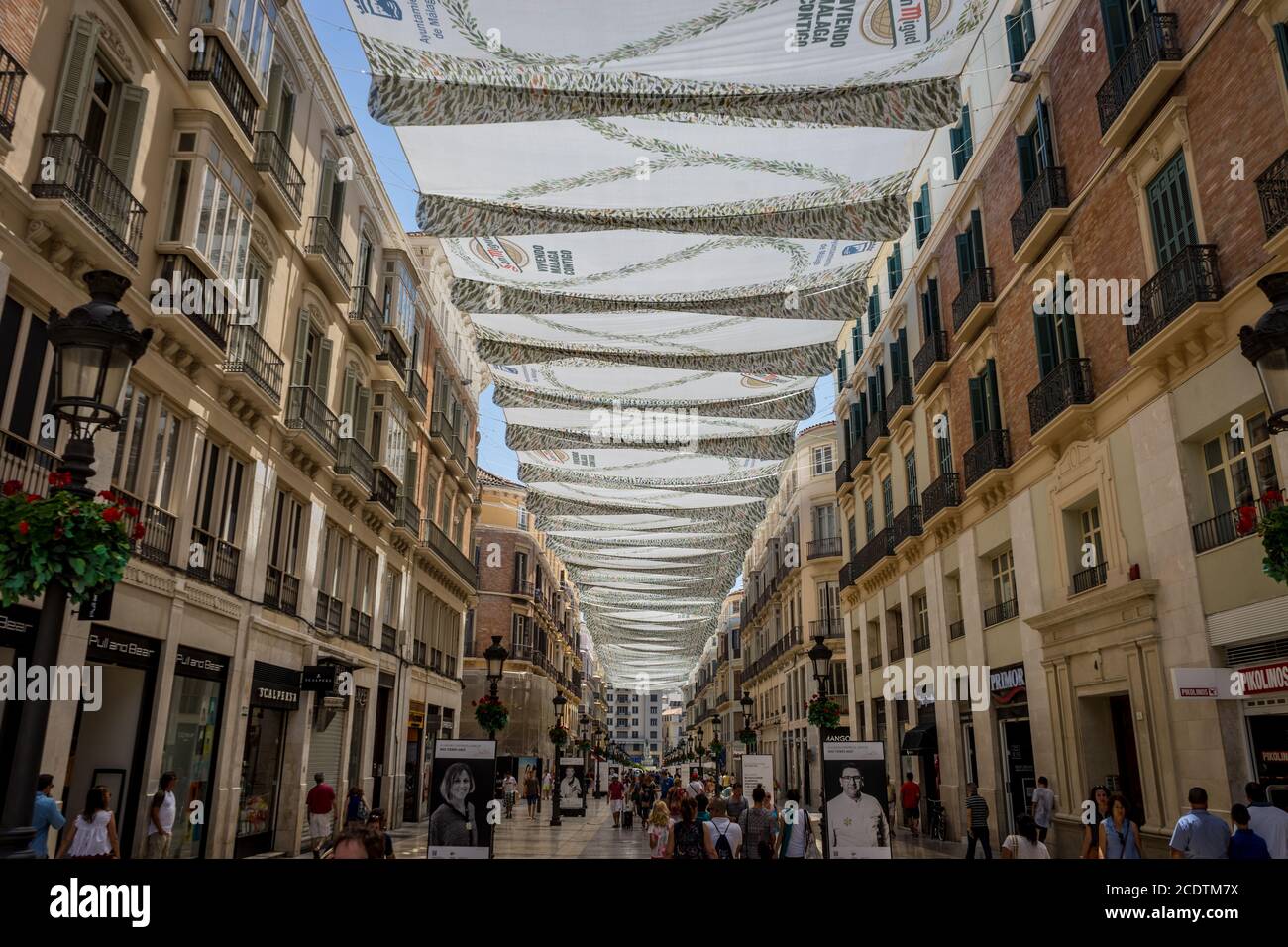Malaga, Spain - June 24: Cloth is hung over the shopping street in the city of Malaga, Spain, Europe Stock Photo