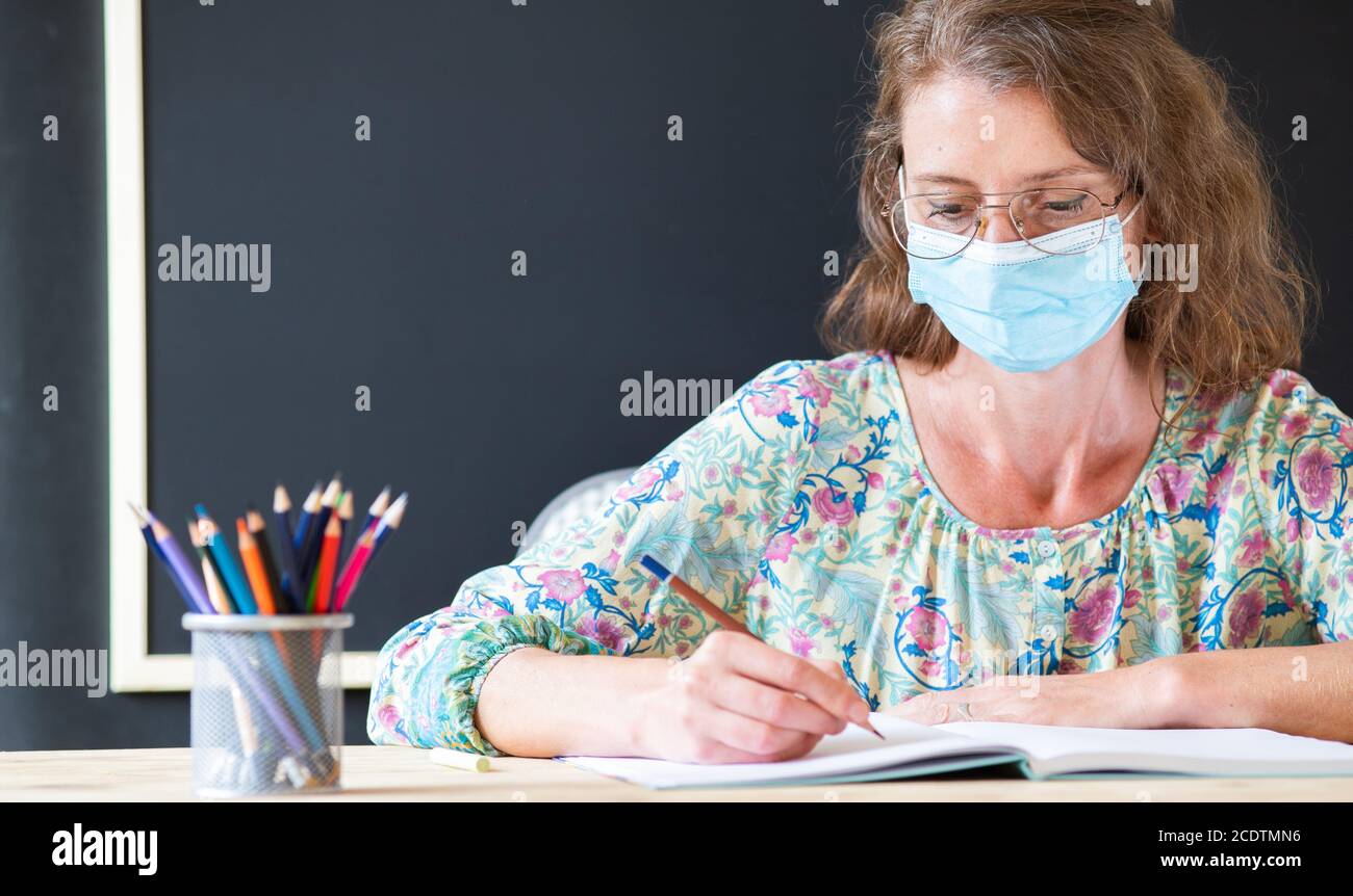 teacher wearing face mask back to school during covid pandemics Stock