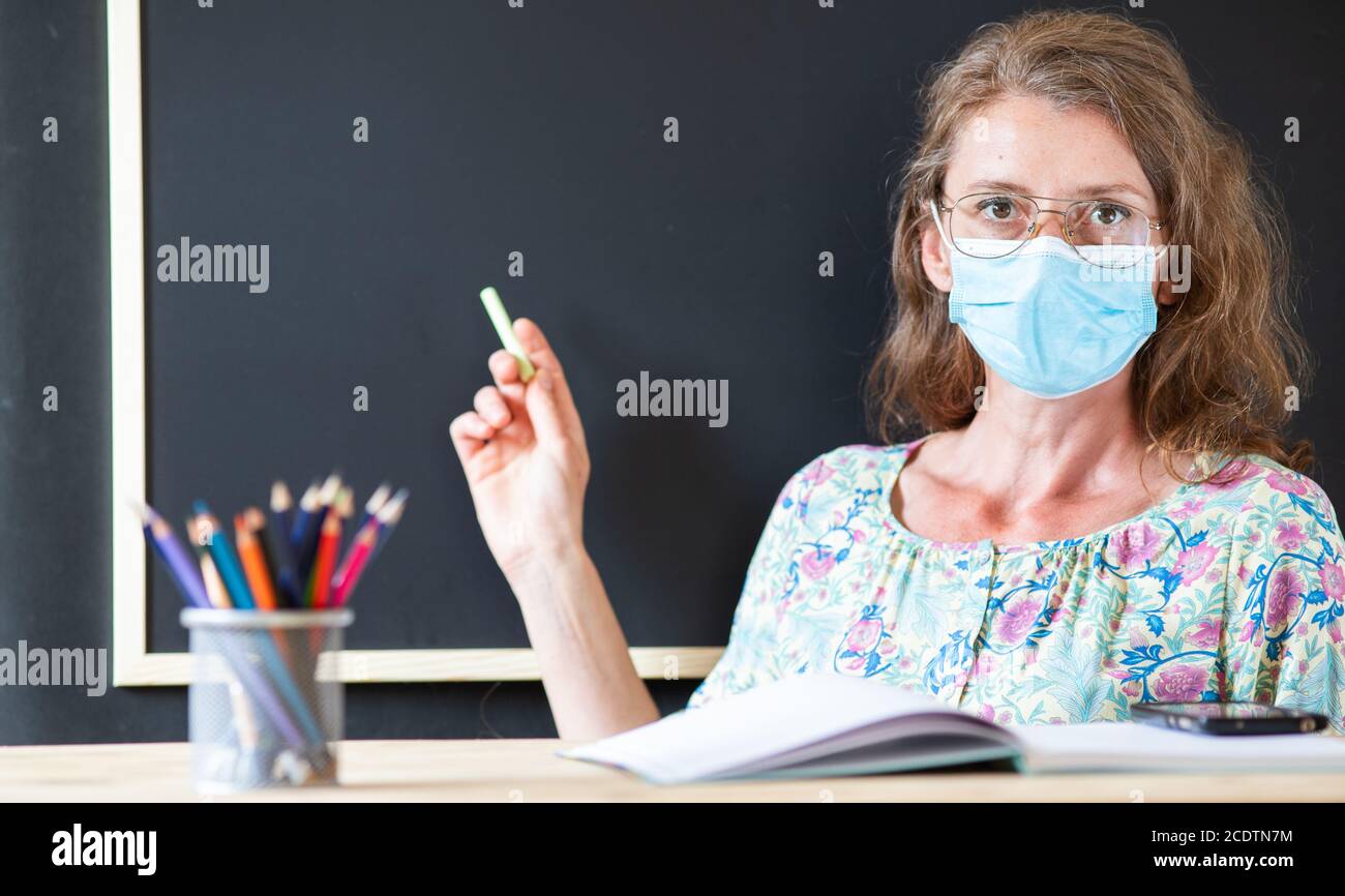 teacher wearing face mask back to school during covid pandemics Stock