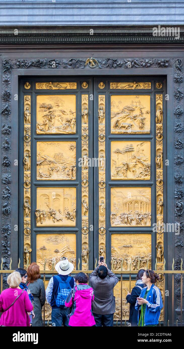 People at the Gates of Paradise at the Baptistery of St. John in Florence, Italy Stock Photo