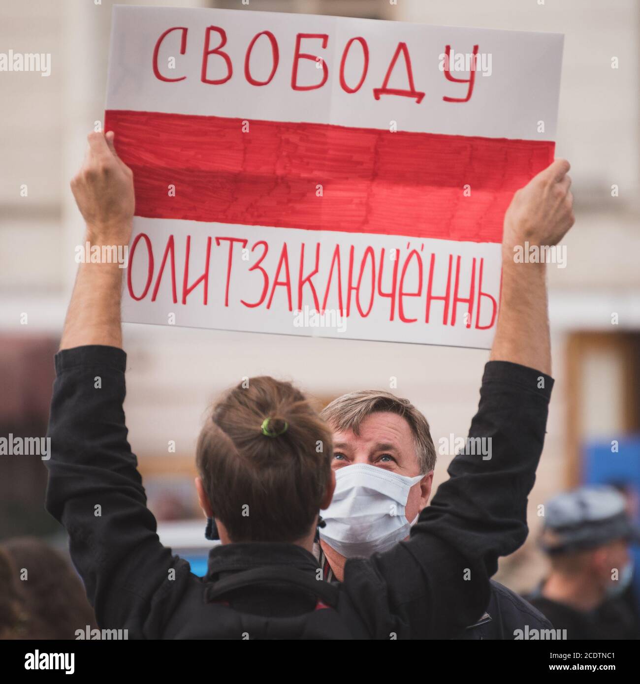 St Petersburg, Russia - August 29, 2020: a passerby looks at poster in hands of protester. Stock Photo