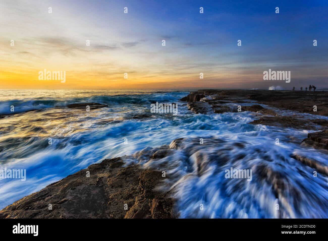 Photographers shooting sunrise at Northern beaches of Sydney - scenic Pacific ocean coast. Stock Photo