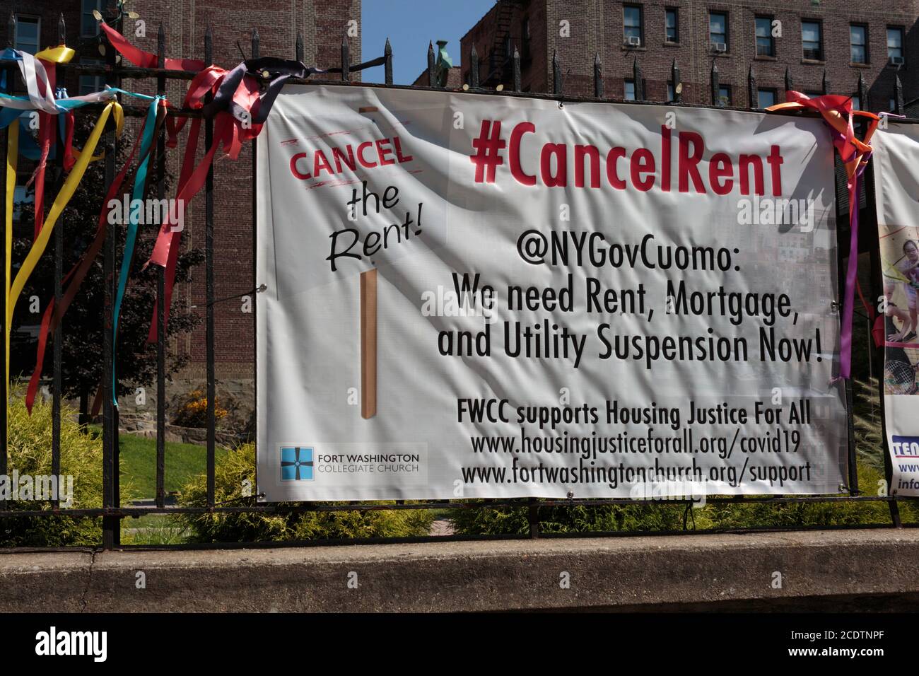 sign hanging on the gate of a church in Northern Manhattan in support of the cancel rent movement in New York in the coronavirus or covid-19 pandemic Stock Photo