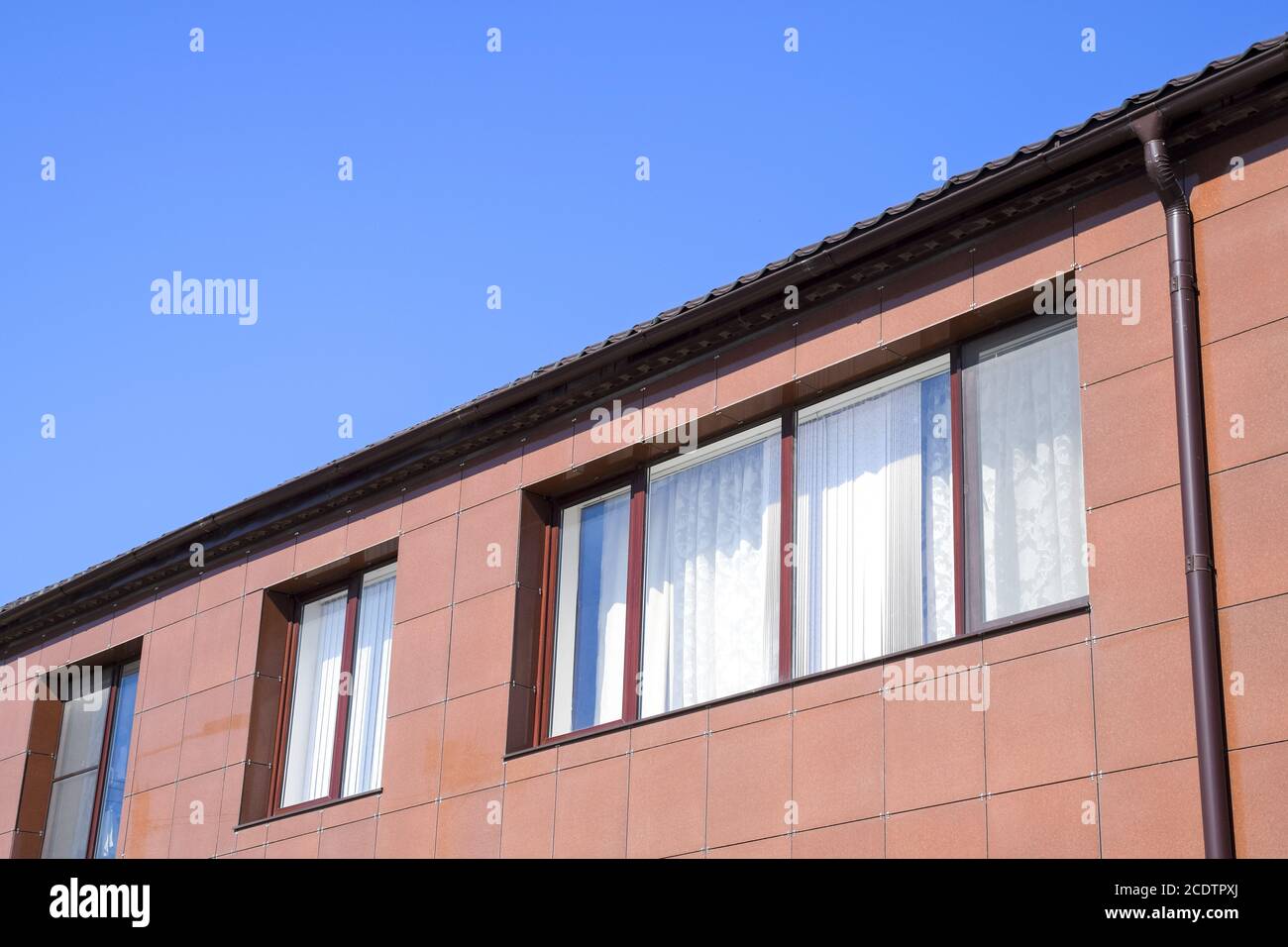 Plastic windows on the house and a spillway system on the roof. House