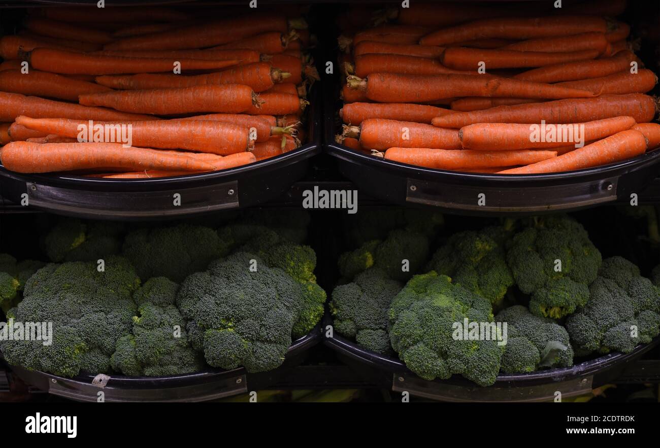 Fresh carrots and broccoli for sale in a grocery store Stock Photo Alamy