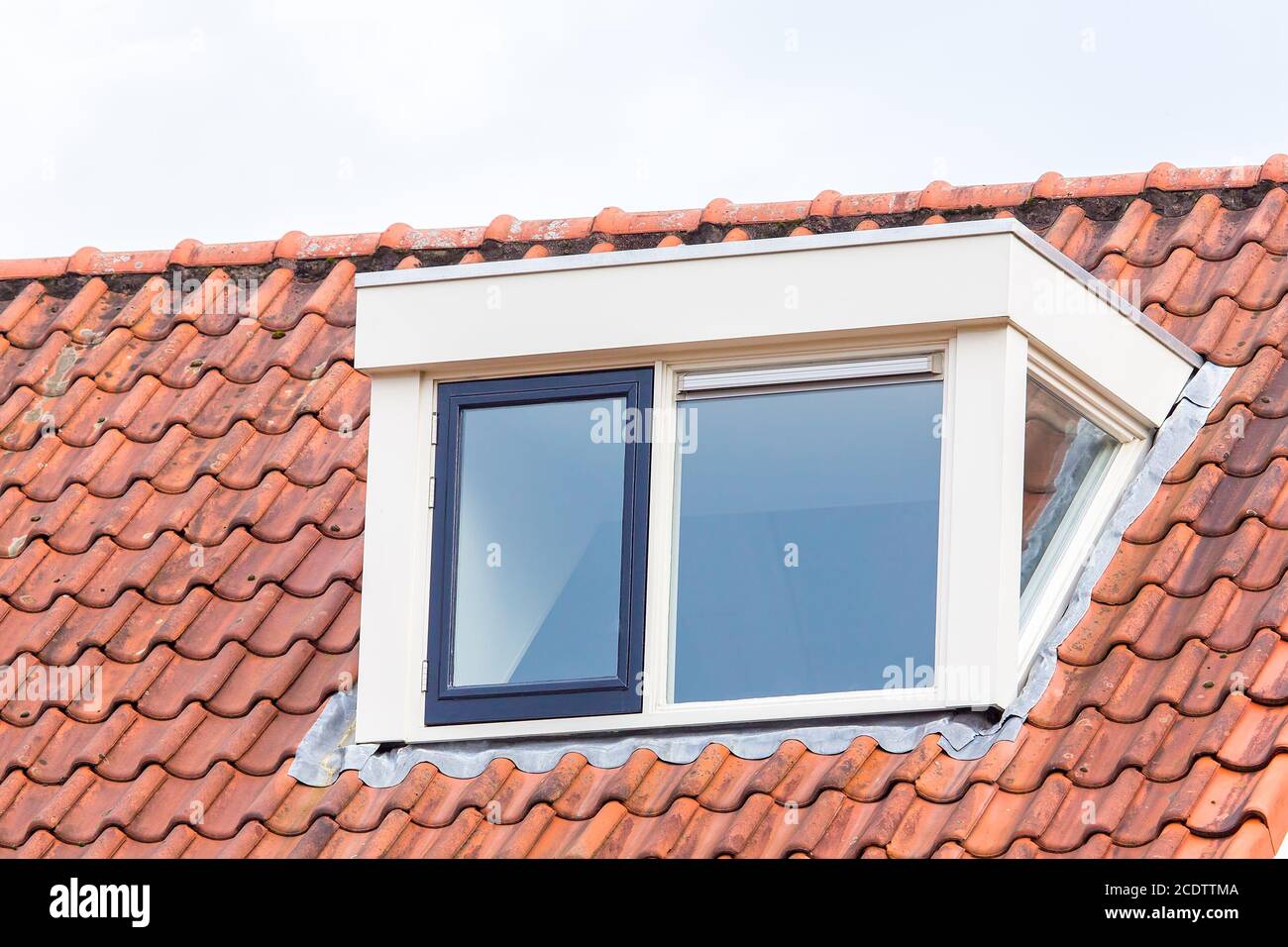 Dormer window on  roof of attic with roof tiles Stock Photo