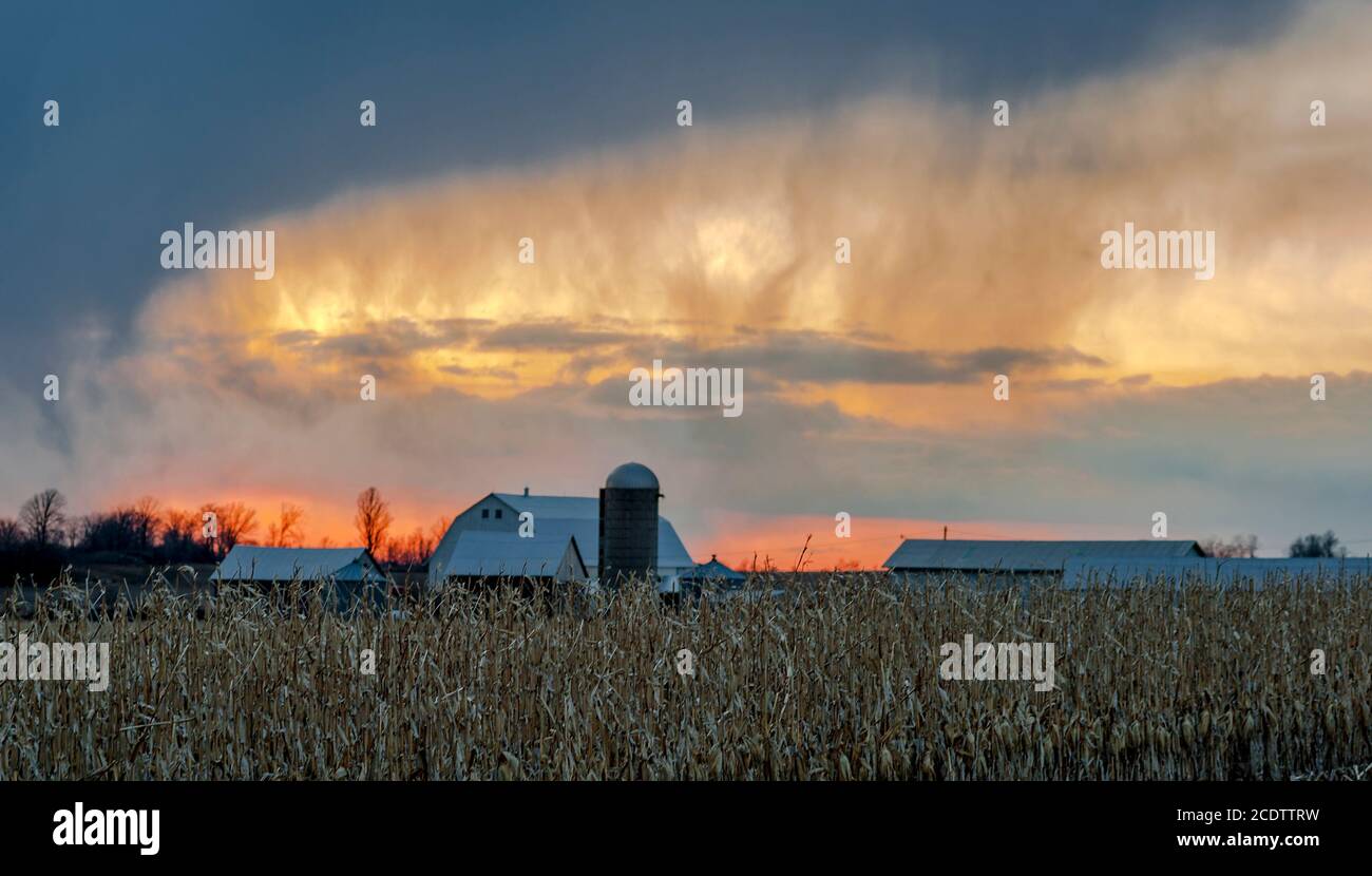 eerie sky at sunset over farm Stock Photo