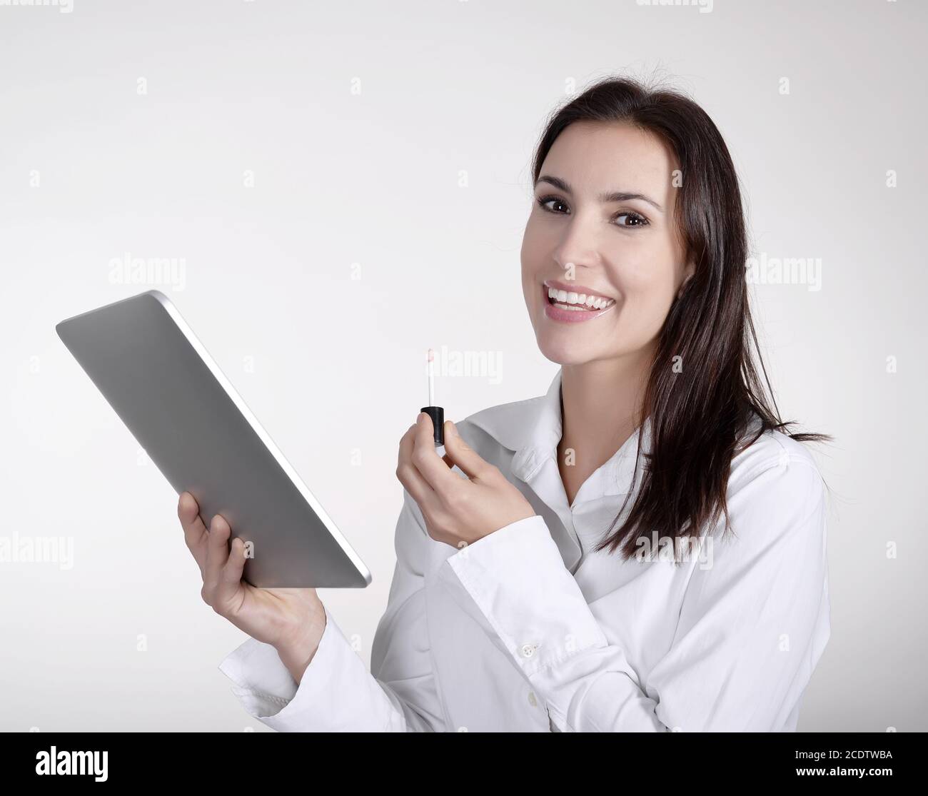 businesswoman with lipstick using digital tablet Stock Photo