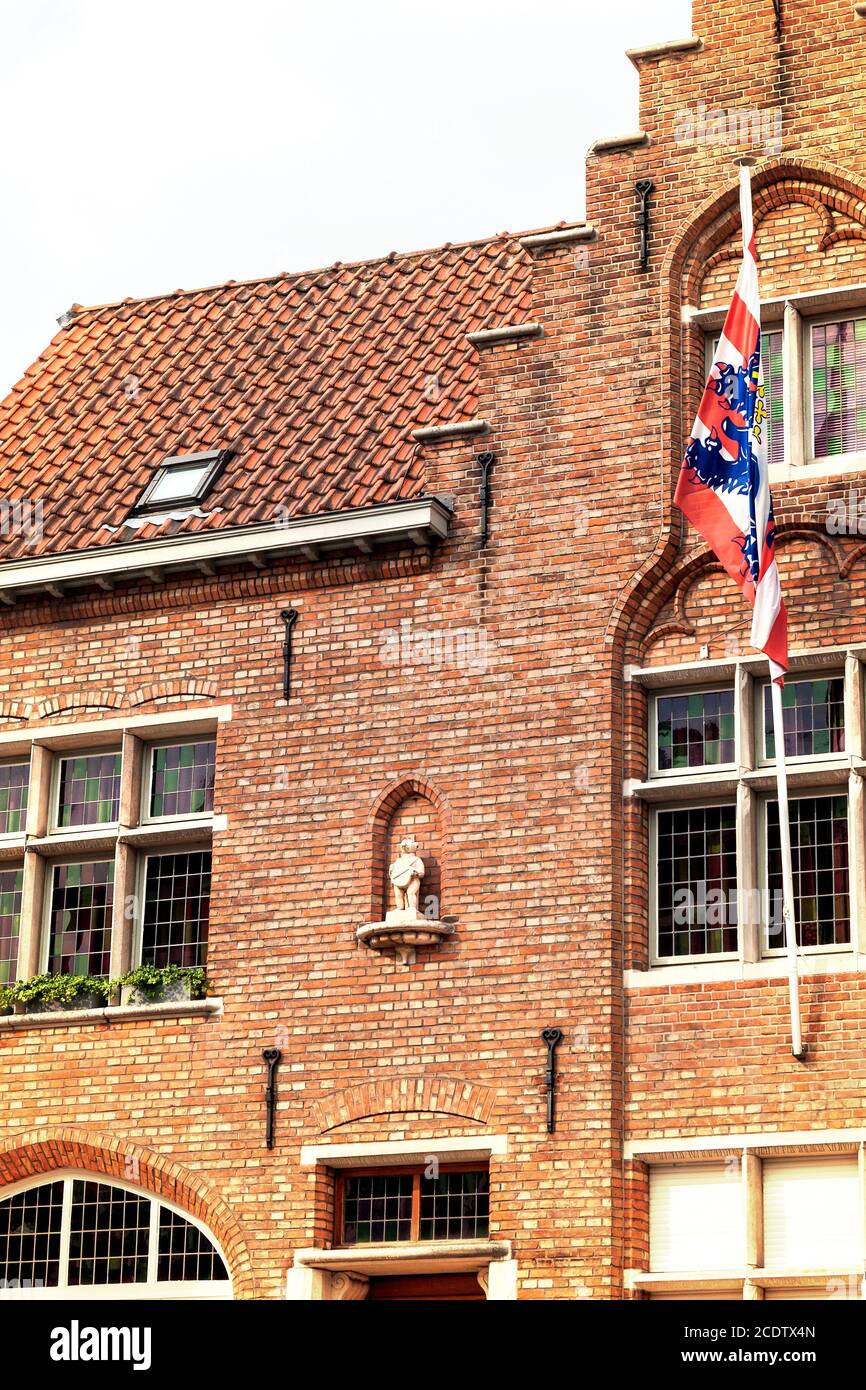 Bruges city symbol, the Brugs Beertje on the facade of the Poortersloge Stock Photo