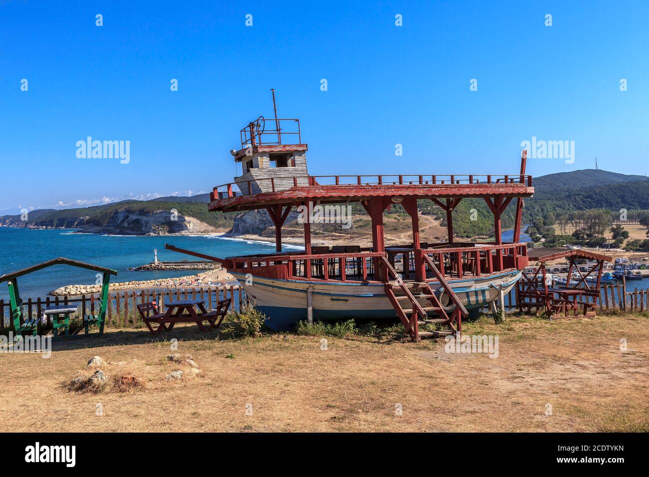 Old boat on the hill, Kiyikoy beach and harbor in the background Stock Photo