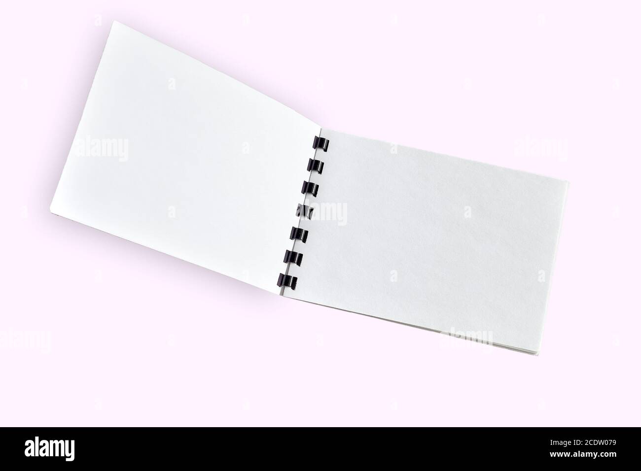 Blank open notebook or brochure close up, isolated on light pink Stock Photo