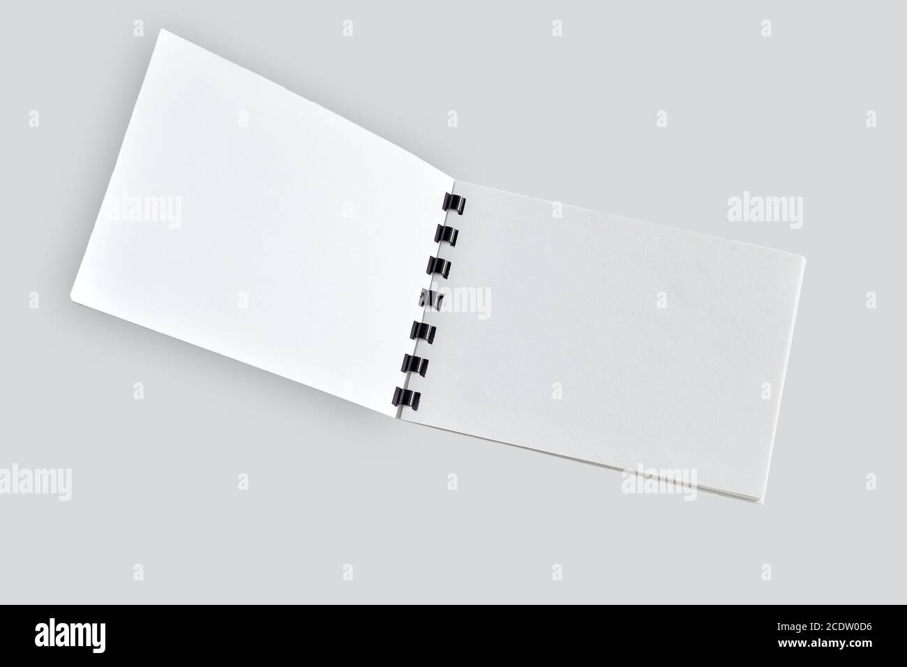 Blank open notebook or brochure close up, isolated on light gray Stock Photo
