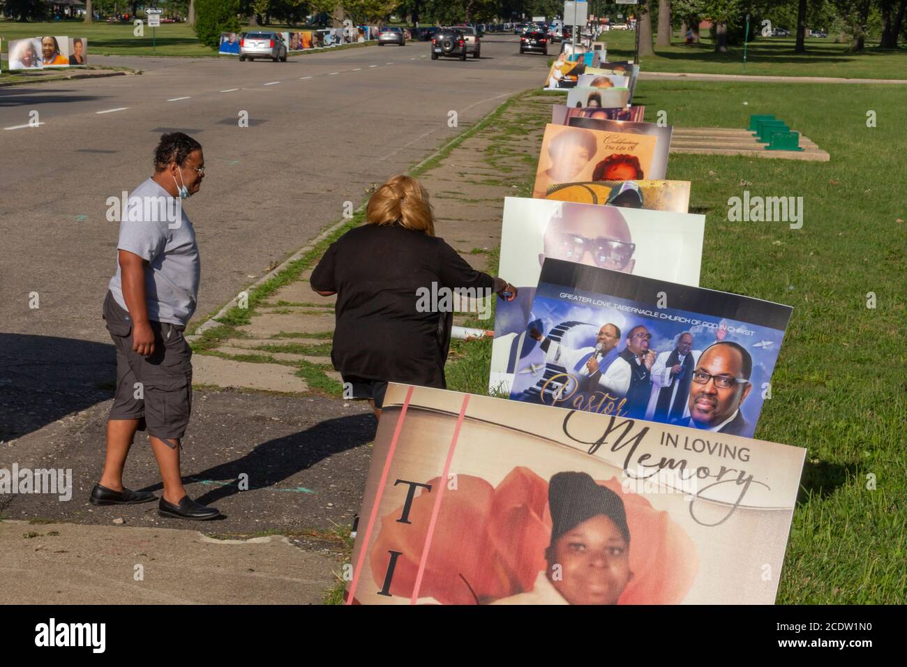 Detroit, Michigan, USA. 29th Aug, 2020. Portraits of Detroit residents who died from Covid-19 lined the roads of Belle Isle State Park as a citywide memorial. The nearly 900 portraits represent the 1,500 Detroiters who died from the virus through August 18. Credit: Jim West/Alamy Live News Stock Photo