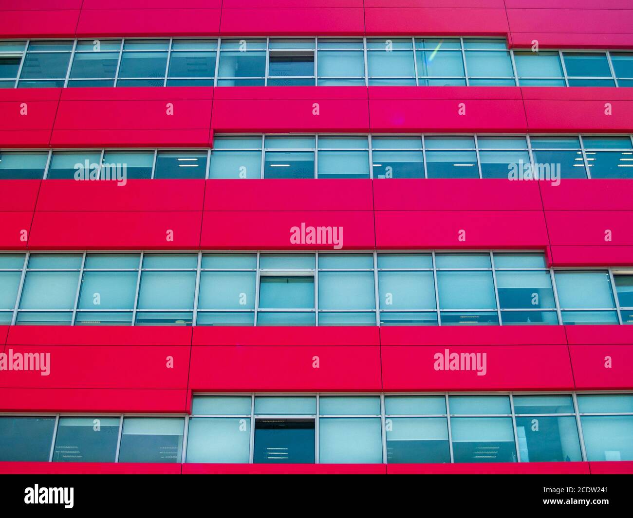 Red modern office building with one open window Stock Photo Alamy