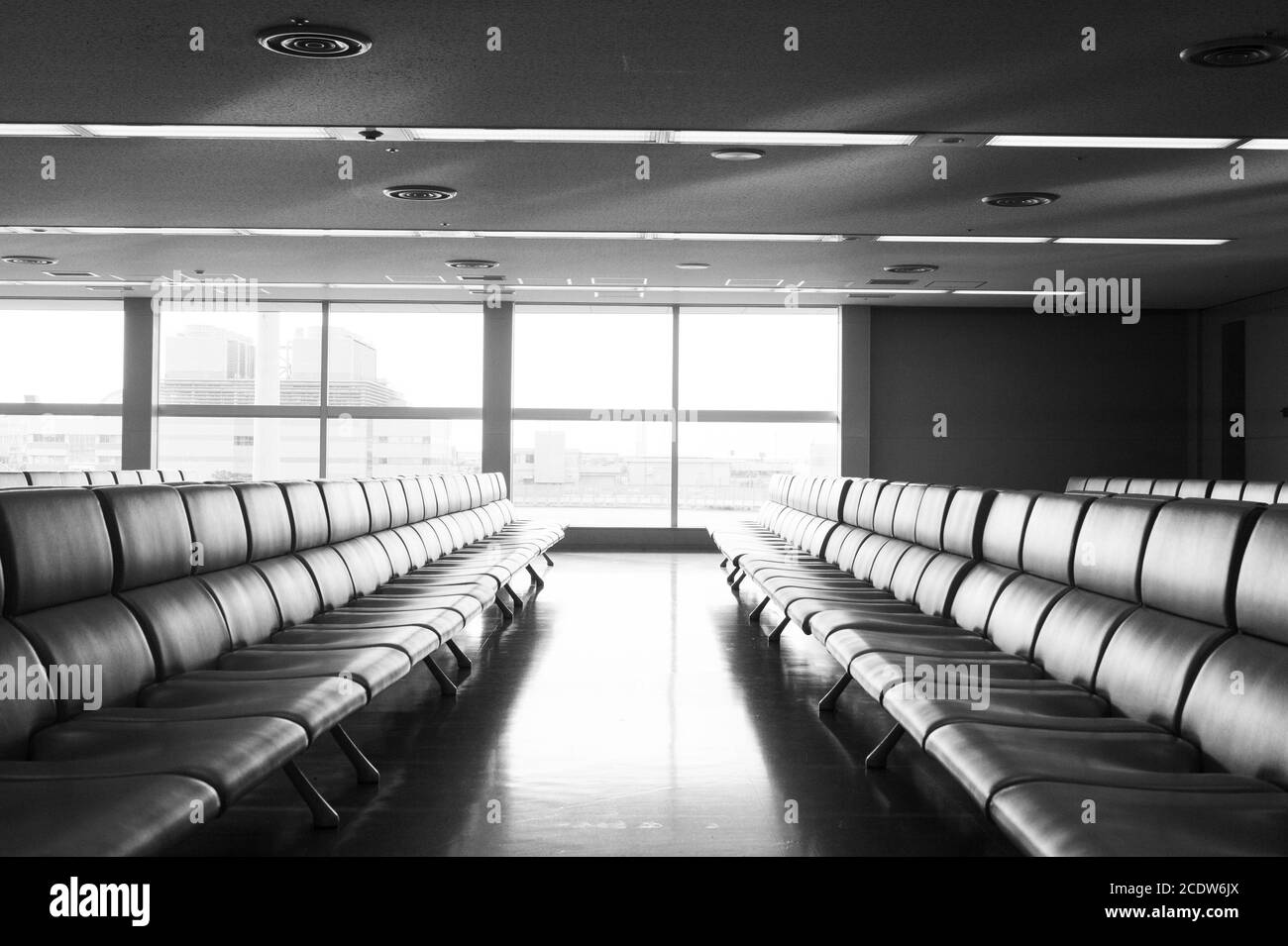 Bench in the terminal of airport , waiting area with chairs Stock Photo