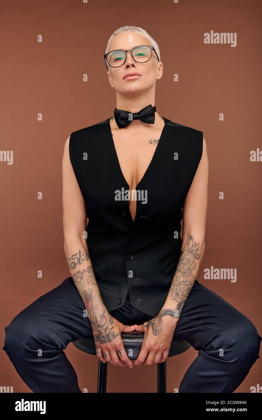 Young Masculine Female With Short Hair And Arms And Body Covered By Tattoos Stock Photo Alamy