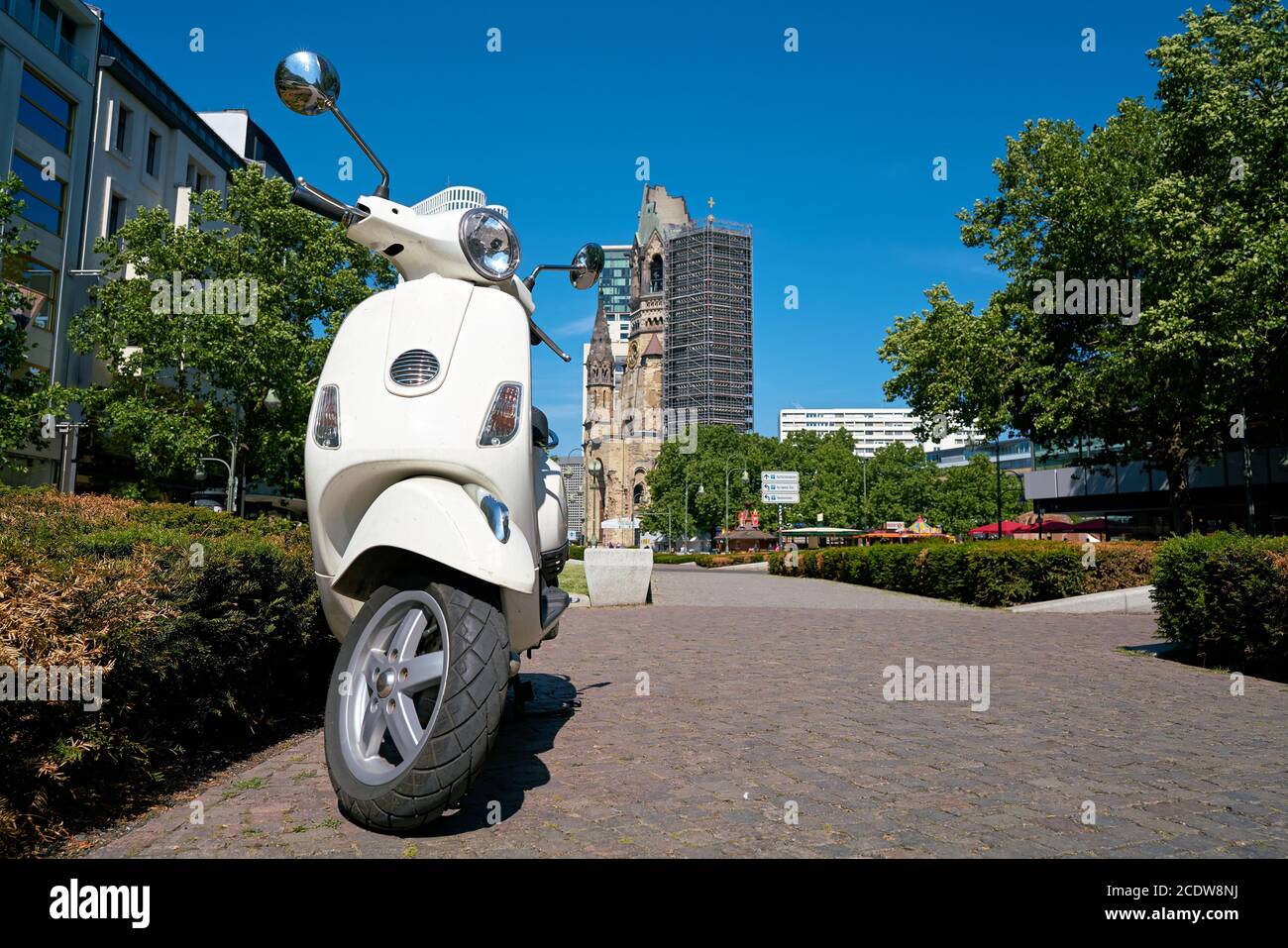 Parked scooter in downtown Berlin. In the background is the Memorial Church, Stock Photo
