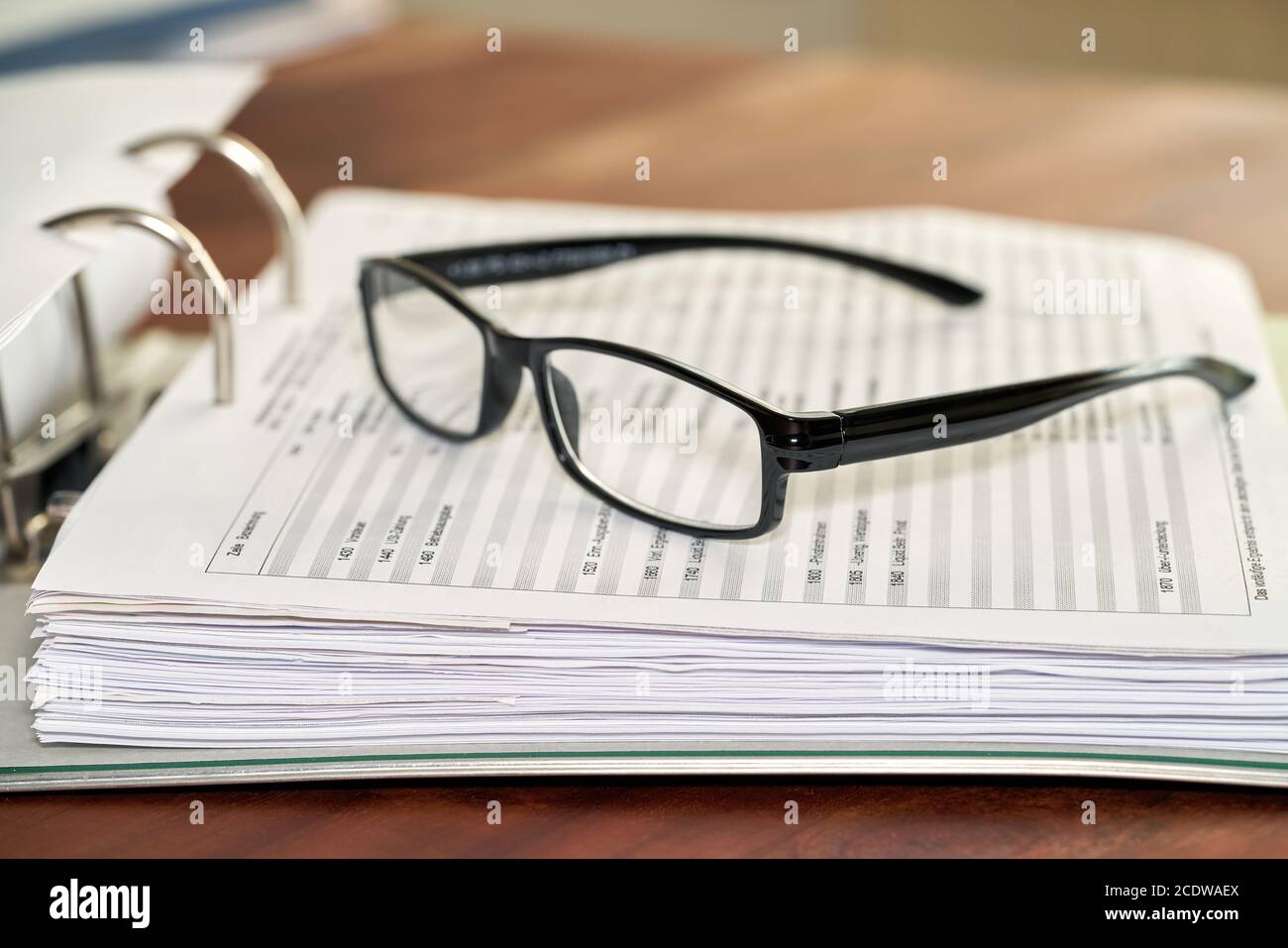 Glasses on a file folder in an office Stock Photo