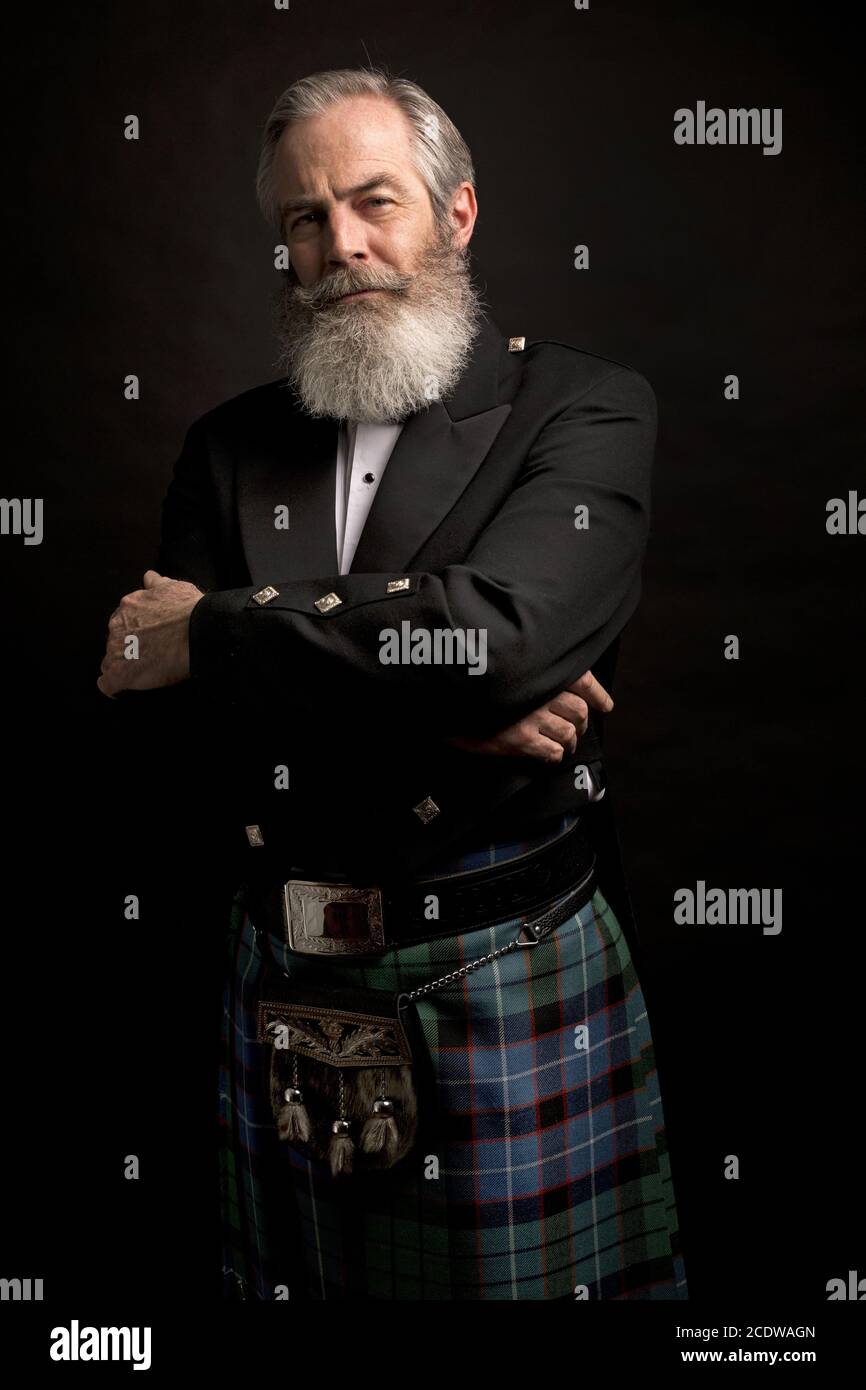 mature male model wearing kilt with grey hairstyle and beard Stock Photo