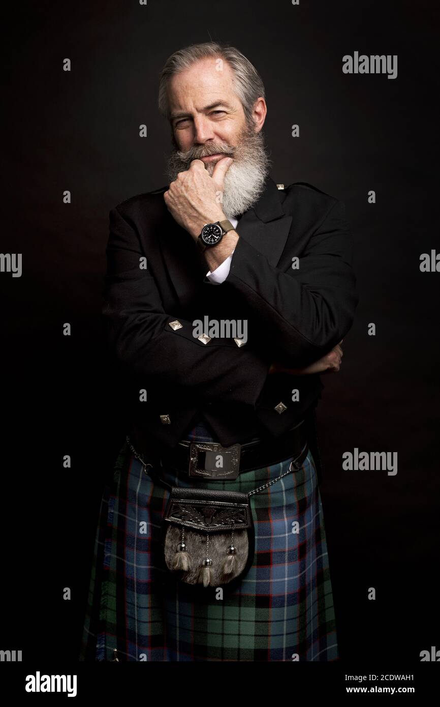 mature male model wearing kilt with grey hairstyle and beard Stock Photo