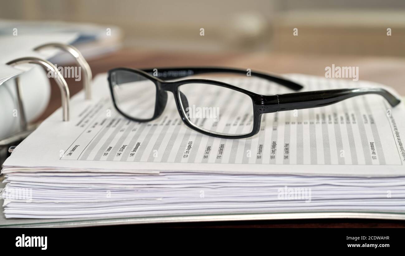 Glasses on a file folder in an office Stock Photo