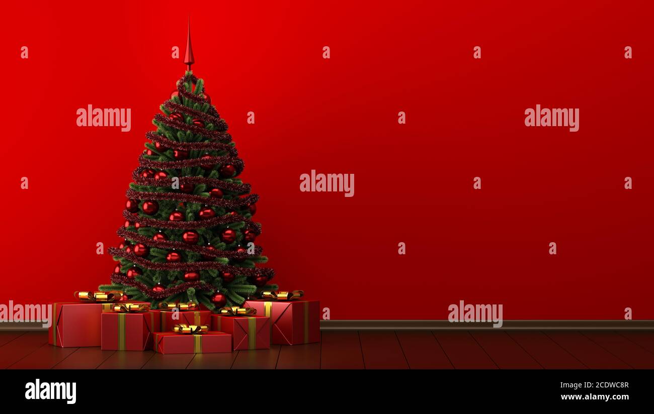 decorated christmas tree with gift boxes in red room Stock Photo