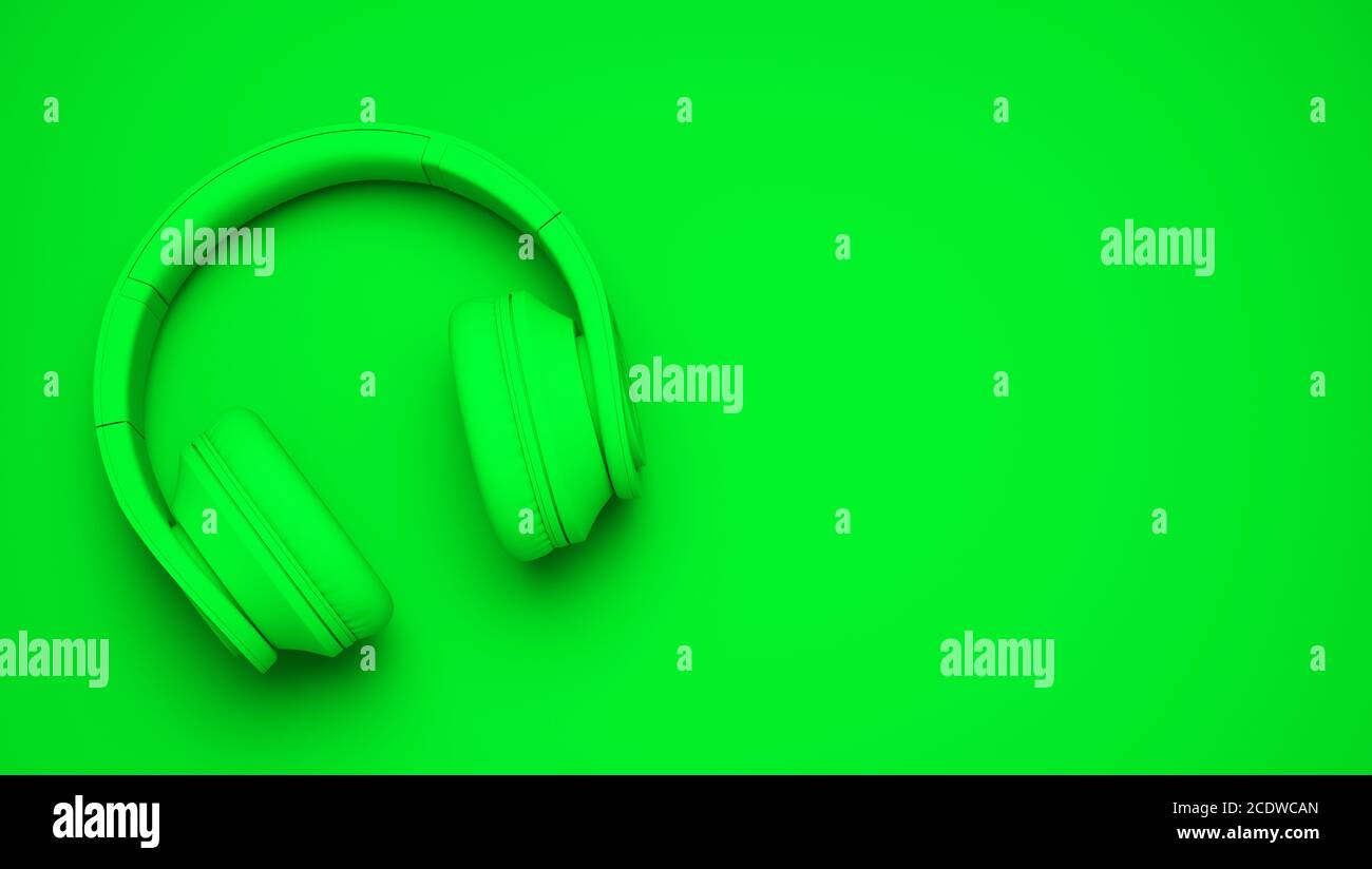 green wireless headphones isolated on green background Stock Photo