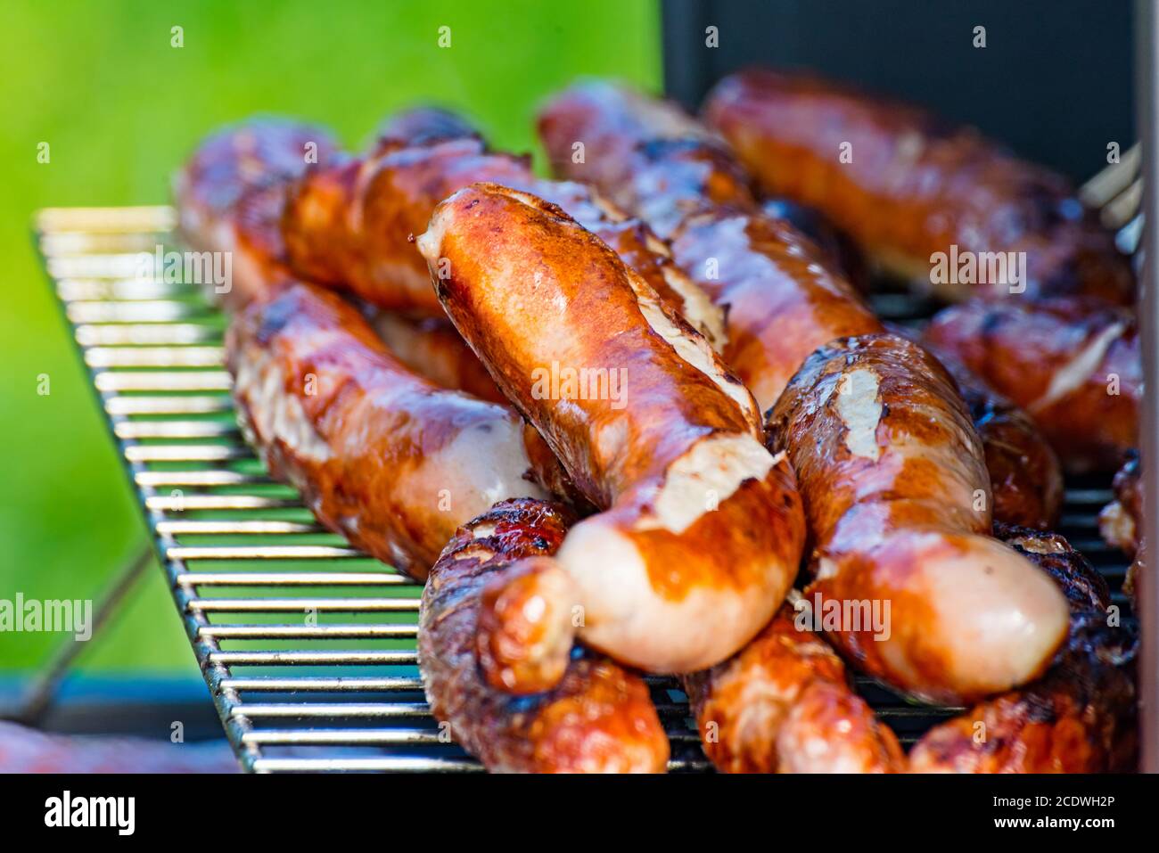 Brat sausages are grilled on the charcoal grill Stock Photo