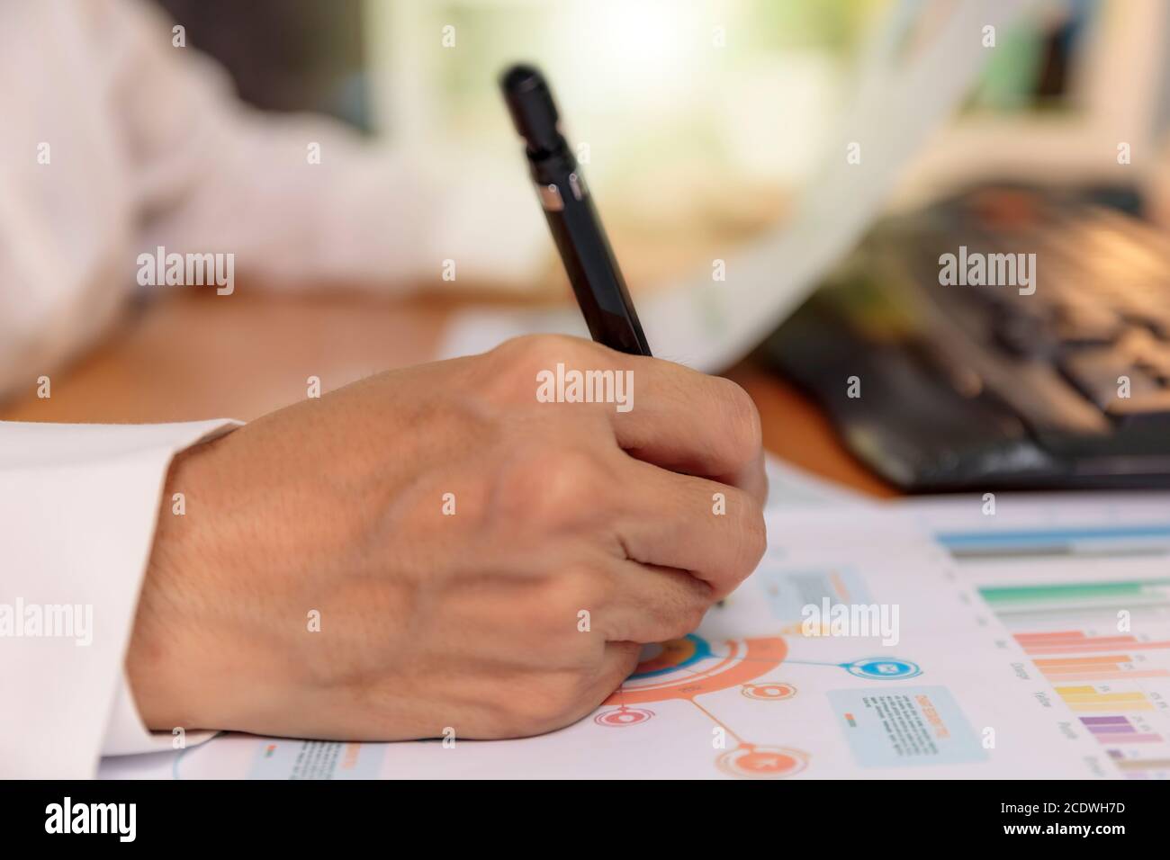 Close up hands of business women use pen writing chart on paper ...