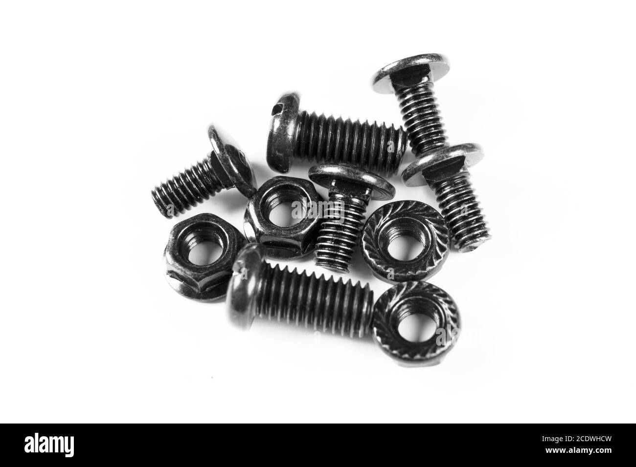 Black metal bolts and nuts  in a row. Black screw bolts and nuts isolated. Steel bolts and nuts pattern. Stock Photo