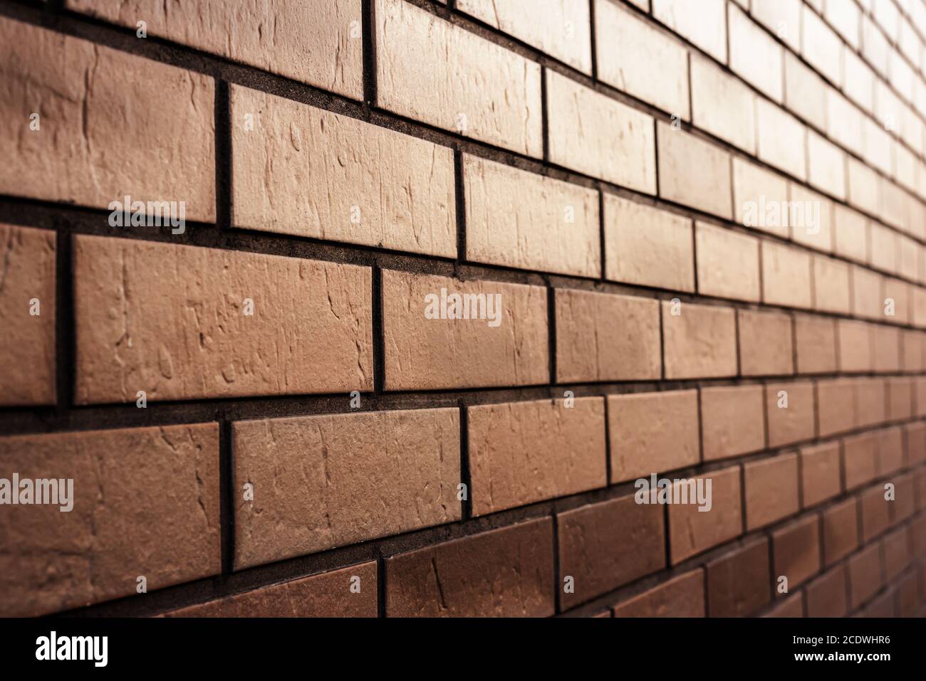 Brown brick wall in perspective. Abstract textured background. Space for text Stock Photo