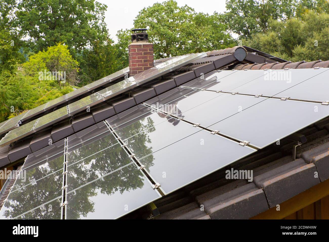 Roof surface of house with black solar panels Stock Photo