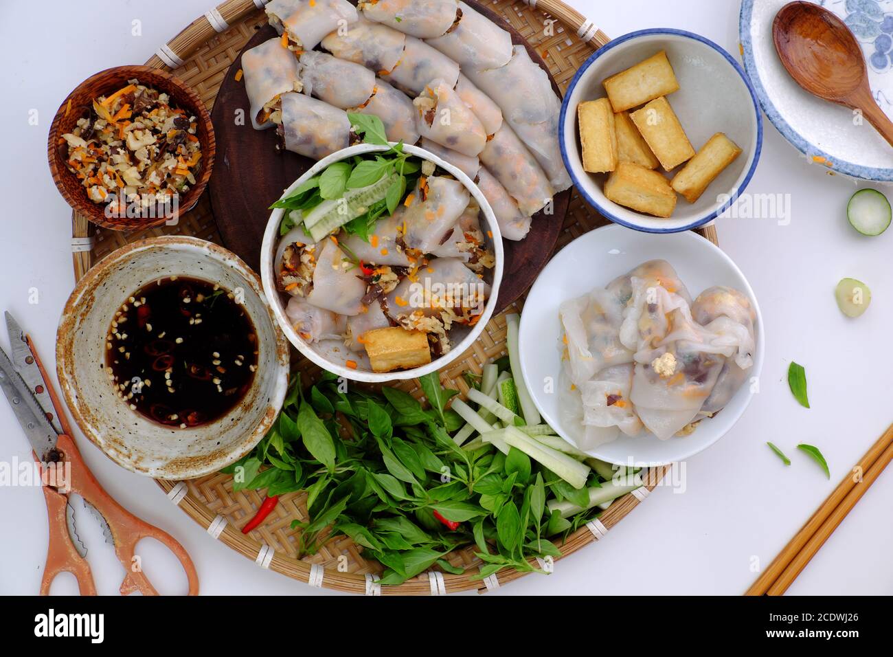 Top view tray of Vietnamese food ready to eat for breakfast, homemade vegan rice noodles roll from rice batter, wood ear mushroom, carrot, tofu Stock Photo