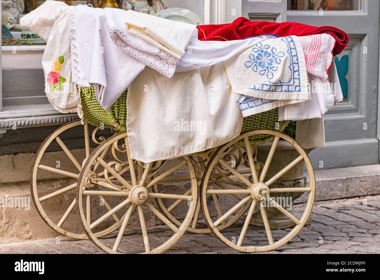 Old-fashioned baby carriage with wooden wheels Stock Photo